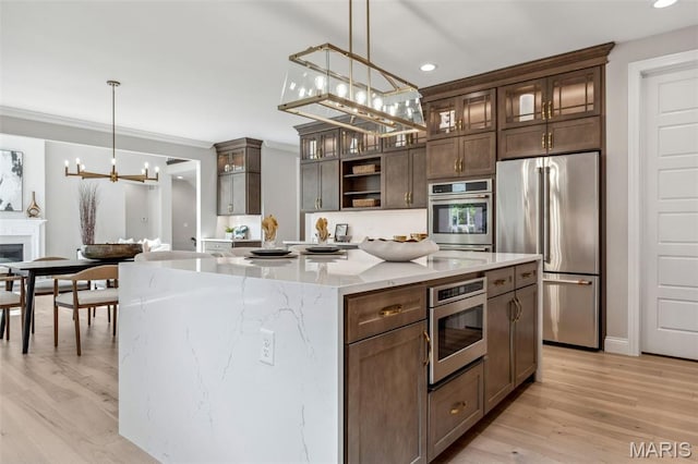 973 Tara Ct, Chesterfield, MO 63005 - kitchen with stainless steel appliances, a chandelier, glass insert cabinets, open shelves, and recessed lighting
