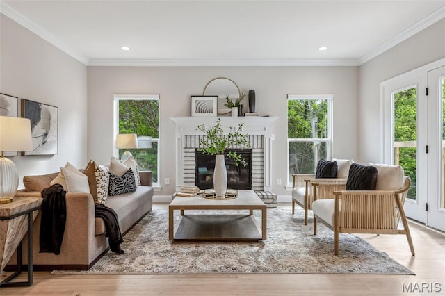 973 Tara Ct, Chesterfield, MO 63005 - living room featuring healthy amount of natural light, wood finished floors, crown molding, a glass covered fireplace, and recessed lighting