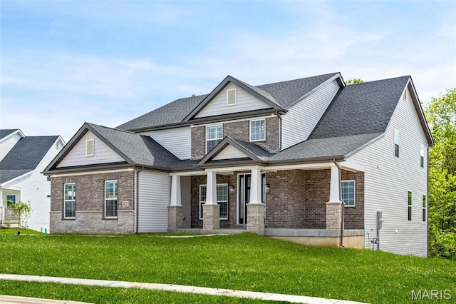 973 Tara Ct, Chesterfield, MO 63005 - craftsman-style house with a front lawn, roof with shingles, covered porch, and stone siding