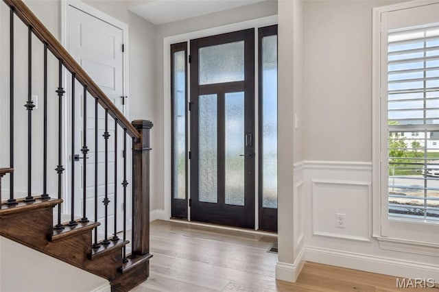 973 Tara Ct, Chesterfield, MO 63005 - foyer entrance featuring stairs, light wood finished floors, a wainscoted wall, and a decorative wall