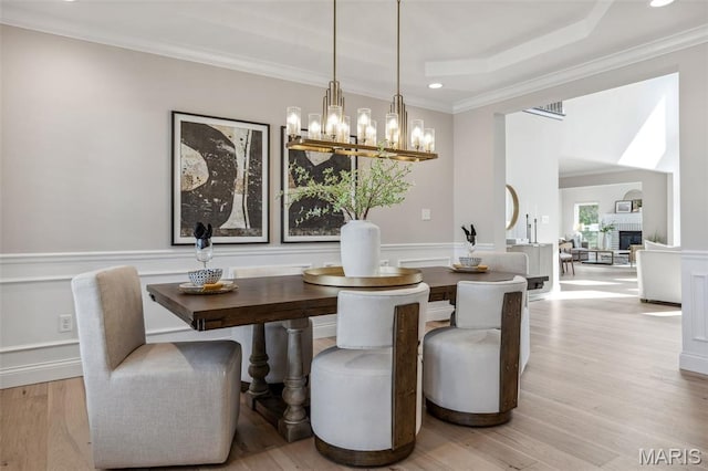 973 Tara Ct, Chesterfield, MO 63005 - dining space with a chandelier, ornamental molding, a raised ceiling, recessed lighting, and light wood-type flooring