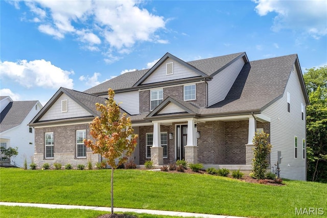 973 Tara Ct, Chesterfield, MO 63005 - craftsman-style house featuring a front yard, brick siding, and roof with shingles