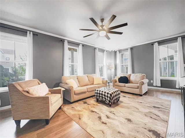3242 Camp St, Saint Charles, MO 63301 - living room featuring wood finished floors, a ceiling fan, plenty of natural light, and ornamental molding