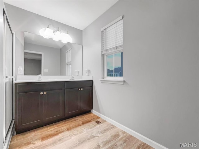 3242 Camp St, Saint Charles, MO 63301 - full bathroom featuring wood finished floors, double vanity, and baseboards