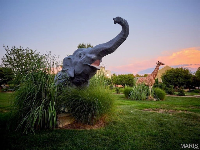 3242 Camp St, Saint Charles, MO 63301 - yard at dusk featuring a lawn
