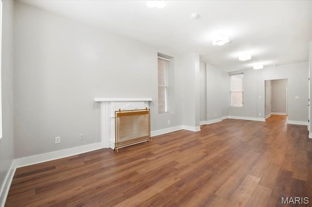 3431 California Ave, Saint Louis, MO 63118 - unfurnished living room featuring wood finished floors, a fireplace, and baseboards