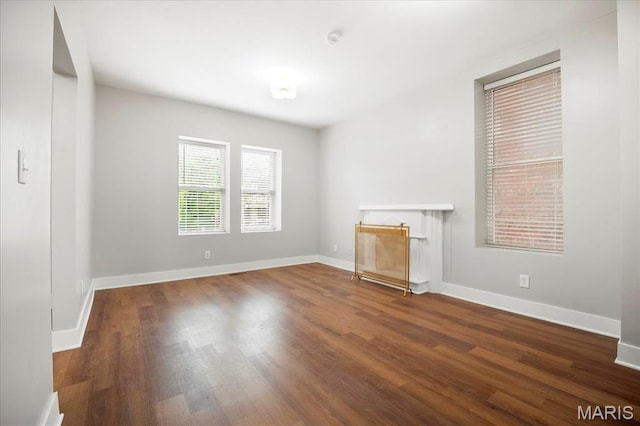 3431 California Ave, Saint Louis, MO 63118 - unfurnished living room with wood finished floors and baseboards