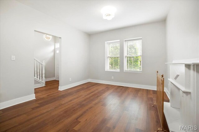 3431 California Ave, Saint Louis, MO 63118 - unfurnished room featuring wood finished floors, baseboards, and stairs