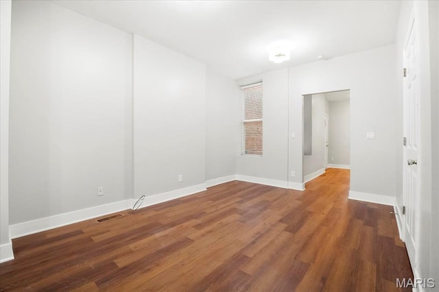 3431 California Ave, Saint Louis, MO 63118 - spare room featuring wood finished floors and baseboards