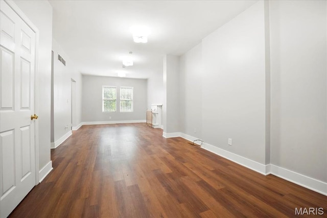 3431 California Ave, Saint Louis, MO 63118 - empty room featuring dark wood-style floors and baseboards
