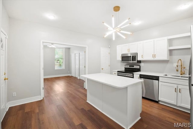 3431 California Ave, Saint Louis, MO 63118 - kitchen featuring appliances with stainless steel finishes, open shelves, a sink, white cabinetry, and light countertops