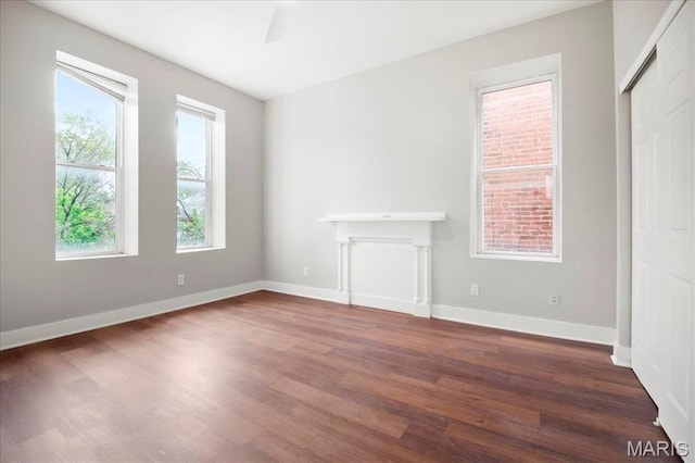 3431 California Ave, Saint Louis, MO 63118 - unfurnished living room with dark wood-type flooring and baseboards