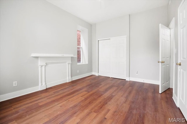 3431 California Ave, Saint Louis, MO 63118 - unfurnished bedroom with wood finished floors, baseboards, and a closet