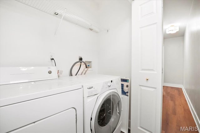 3431 California Ave, Saint Louis, MO 63118 - washroom with separate washer and dryer, wood finished floors, and baseboards