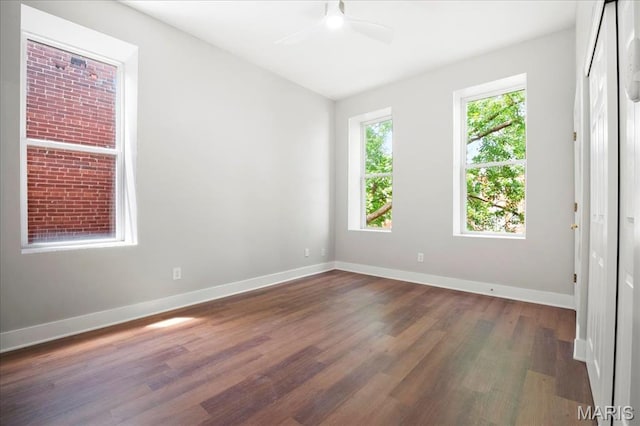 3431 California Ave, Saint Louis, MO 63118 - spare room featuring dark wood finished floors, a ceiling fan, and baseboards