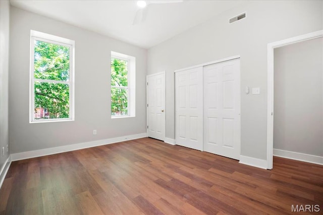 3431 California Ave, Saint Louis, MO 63118 - unfurnished bedroom featuring dark wood-style floors, baseboards, a closet, and a ceiling fan