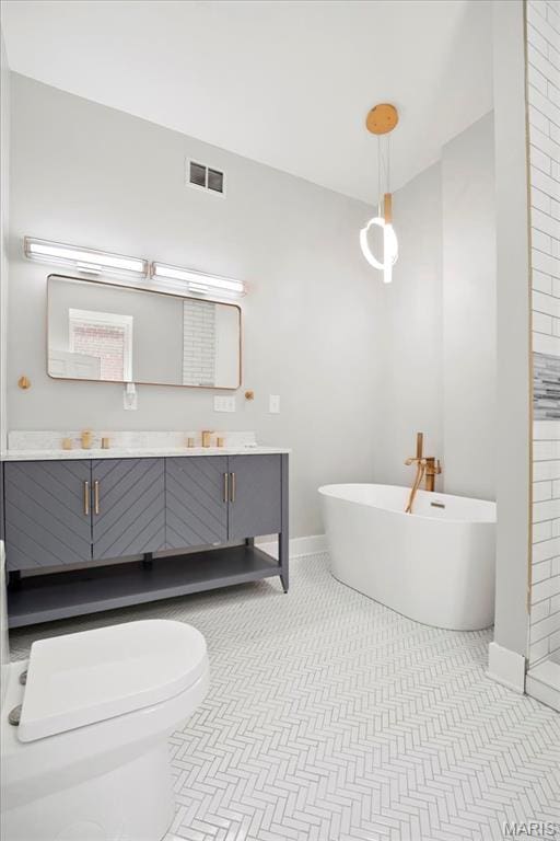 3431 California Ave, Saint Louis, MO 63118 - full bathroom with a freestanding bath, baseboards, vanity, and toilet