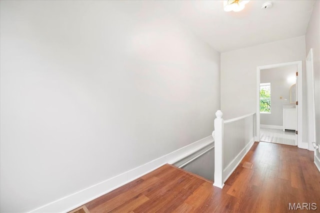3431 California Ave, Saint Louis, MO 63118 - hallway with an upstairs landing, wood finished floors, and baseboards