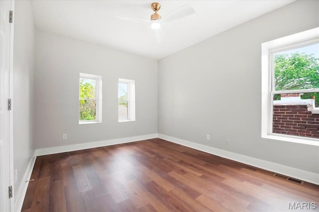 3431 California Ave, Saint Louis, MO 63118 - unfurnished room featuring healthy amount of natural light, wood finished floors, a ceiling fan, and baseboards
