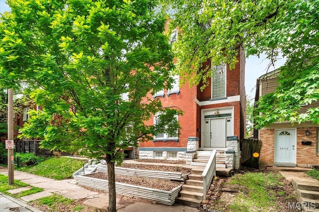 3431 California Ave, Saint Louis, MO 63118 - view of property with brick siding and a vegetable garden