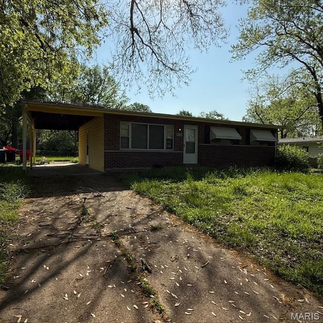 9732 Glen Owen Dr, Saint Louis, MO 63136 - view of front facade with brick siding, asphalt driveway, and a carport