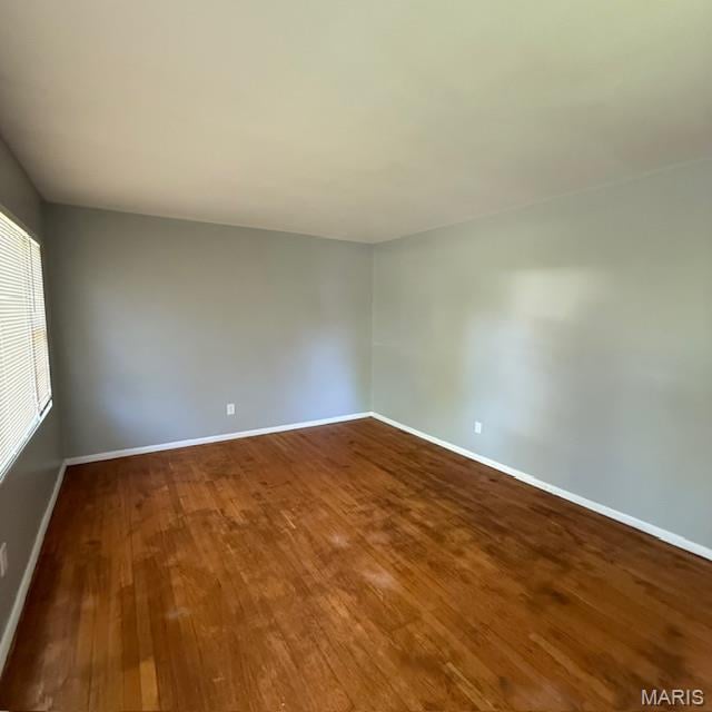 9732 Glen Owen Dr, Saint Louis, MO 63136 - spare room featuring dark wood-style floors and baseboards