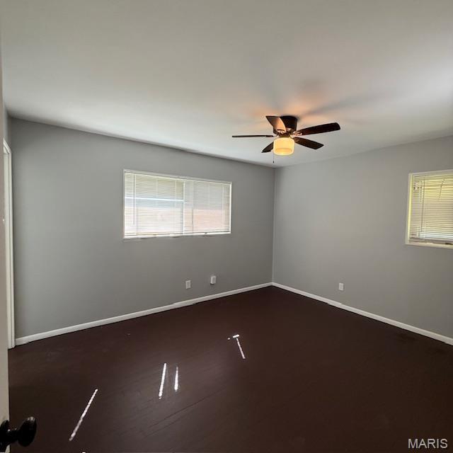 9732 Glen Owen Dr, Saint Louis, MO 63136 - unfurnished room featuring healthy amount of natural light, a ceiling fan, and baseboards