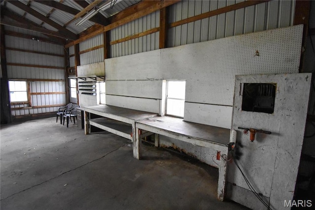 garage with a workshop area and metal wall