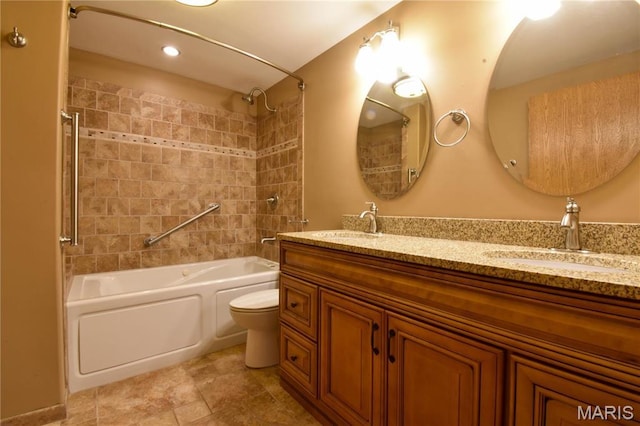 bathroom with washtub / shower combination, toilet, double vanity, and recessed lighting