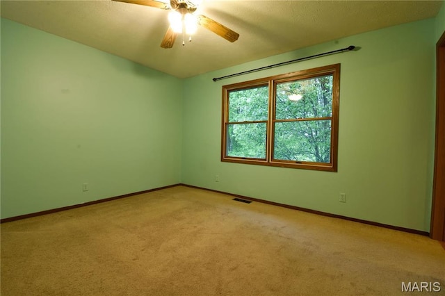 empty room with light carpet, baseboards, and ceiling fan