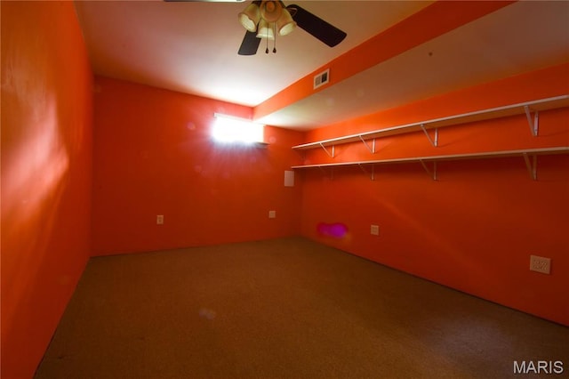spare room featuring carpet flooring and ceiling fan