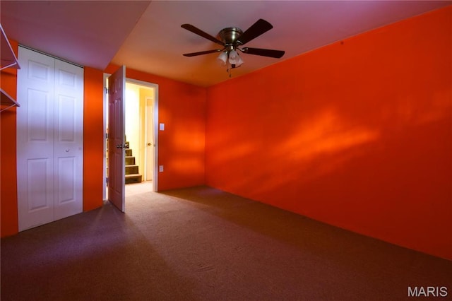 spare room with ceiling fan and carpet floors