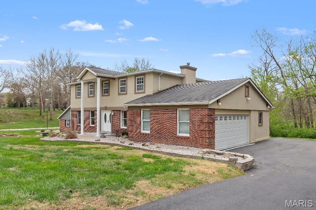 625 Pinebrook Dr, Town And Country, MO 63017 - view of front of home with a garage, driveway, a chimney, stucco siding, and a front yard