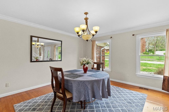625 Pinebrook Dr, Town And Country, MO 63017 - dining space with a chandelier, plenty of natural light, crown molding, and wood finished floors