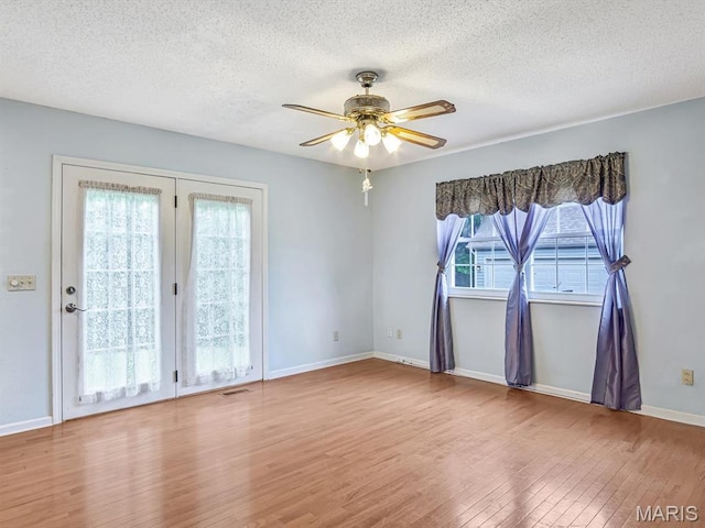 109 Miller Ct, Valmeyer, IL 62295 - empty room with wood finished floors, a ceiling fan, a textured ceiling, and baseboards