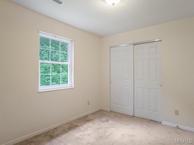 109 Miller Ct, Valmeyer, IL 62295 - unfurnished bedroom with carpet floors, baseboards, a closet, and a textured ceiling