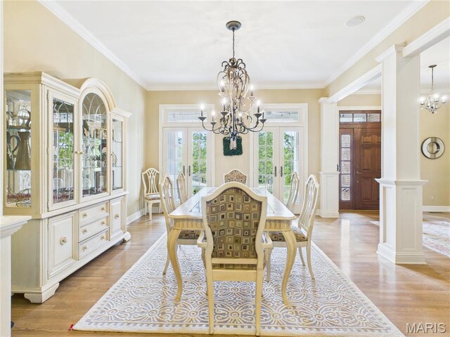 262 Woodland Hill Rd, Poplar Bluff, MO 63901 - dining space featuring french doors, a chandelier, light wood-style floors, and crown molding