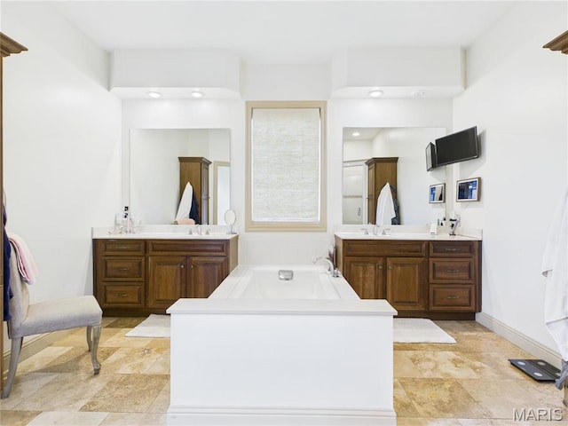 262 Woodland Hill Rd, Poplar Bluff, MO 63901 - full bath with two vanities, a bath, baseboards, a shower, and recessed lighting