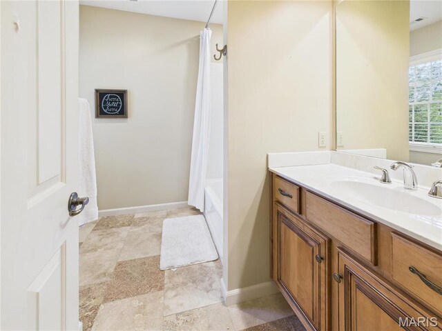 262 Woodland Hill Rd, Poplar Bluff, MO 63901 - full bathroom with vanity, baseboards, shower / bath combo, and stone finish flooring