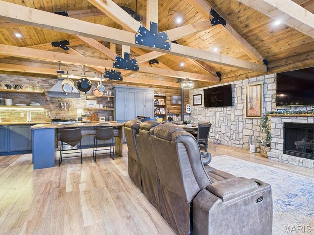 262 Woodland Hill Rd, Poplar Bluff, MO 63901 - living room featuring wooden ceiling, light wood finished floors, and a stone fireplace