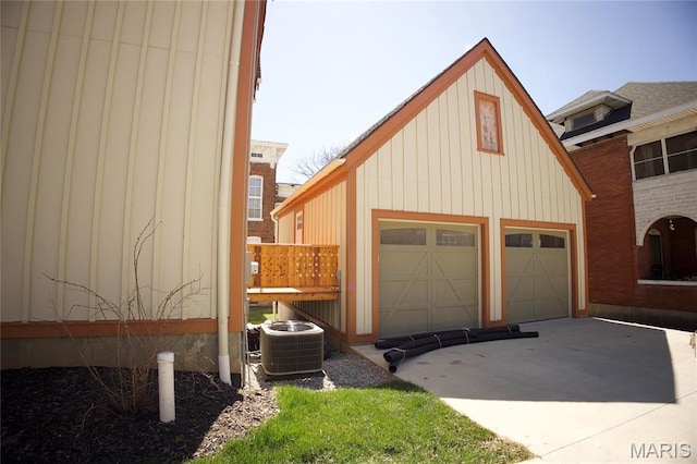 garage featuring driveway and central air condition unit