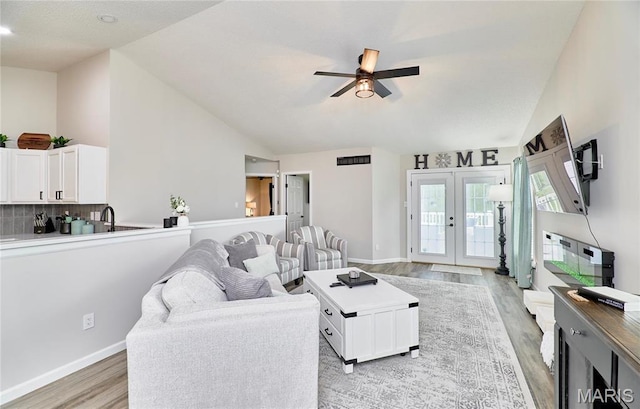 10 Warshire Ct Unit 67B, Ofallon, MO 63366 - living room with light wood finished floors, french doors, lofted ceiling, ceiling fan, and baseboards