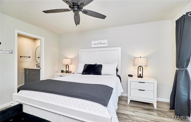 10 Warshire Ct Unit 67B, Ofallon, MO 63366 - bedroom with wood finished floors, connected bathroom, ceiling fan, a textured ceiling, and baseboards