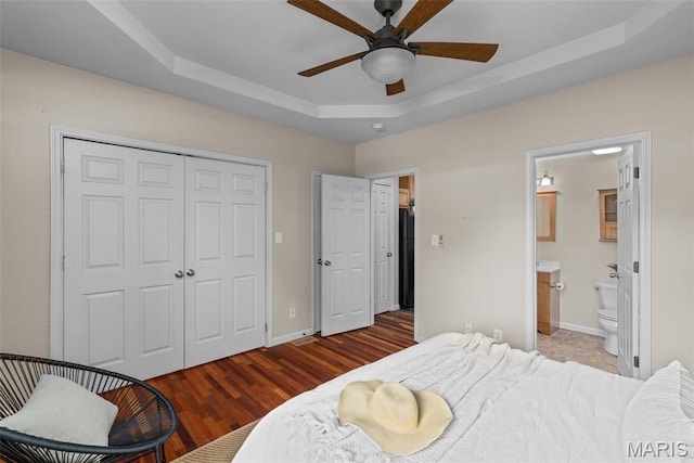 3318 Sidney St, Saint Louis, MO 63104 - bedroom with a tray ceiling, a closet, baseboards, and wood finished floors