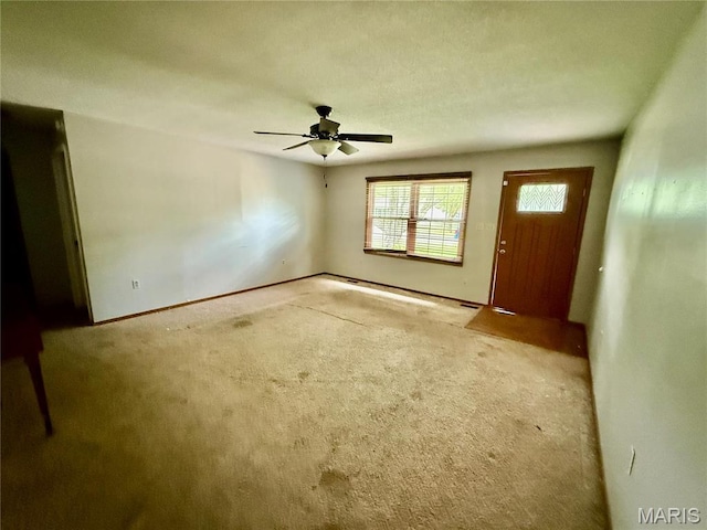 710 Ash St, Greenville, IL 62246 - foyer entrance with carpet flooring, ceiling fan, and baseboards
