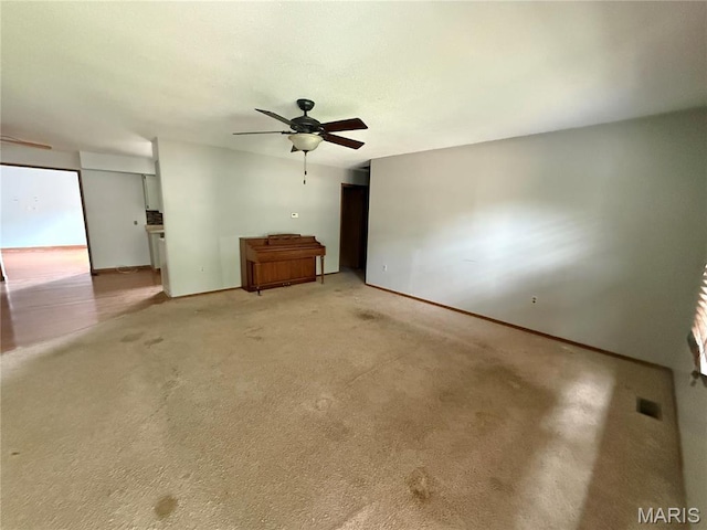 710 Ash St, Greenville, IL 62246 - unfurnished living room with ceiling fan, baseboards, and light colored carpet