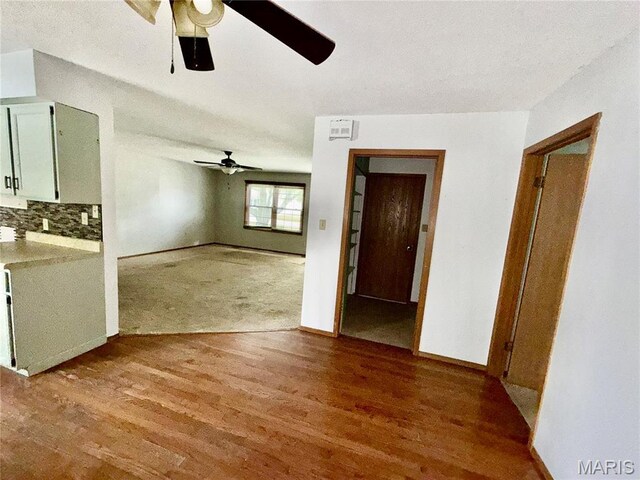 710 Ash St, Greenville, IL 62246 - unfurnished living room featuring a ceiling fan, wood finished floors, and baseboards