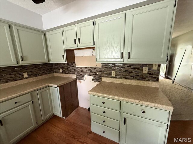 710 Ash St, Greenville, IL 62246 - kitchen featuring tasteful backsplash, dark wood finished floors, and light countertops