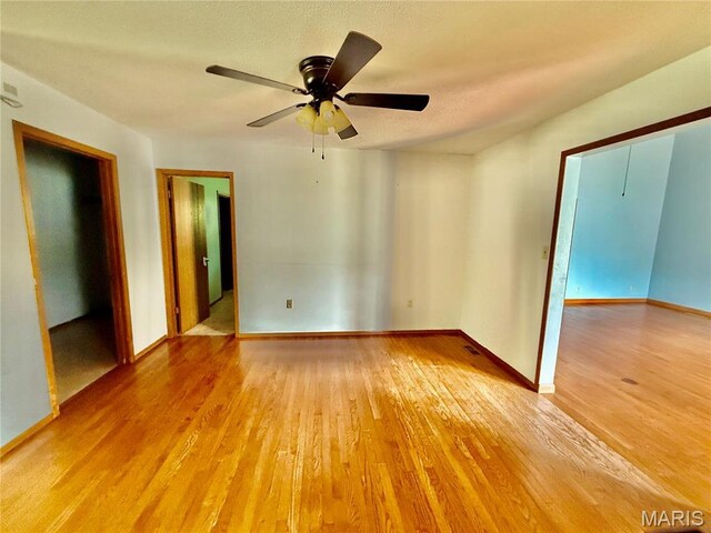 710 Ash St, Greenville, IL 62246 - unfurnished bedroom featuring light wood-type flooring, baseboards, and ceiling fan