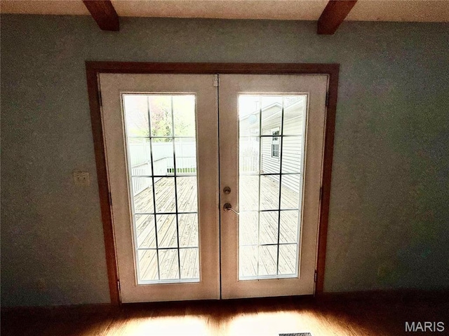 710 Ash St, Greenville, IL 62246 - entryway featuring french doors, beam ceiling, and wood finished floors